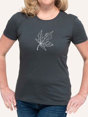 Woman wearing dark grey t-shirt with maple leaf outline line art - Made in Canada by Choose Canadian Apparel Co