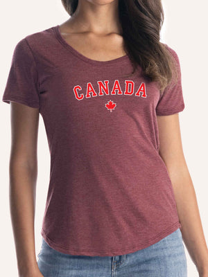 Woman wearing ladies burgundy red t-shirt with red maple leaf graphic and canada block letters - Made in Canada by Choose Canadian Apparel Co