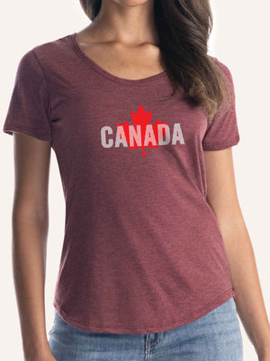 Woman wearing ladies burgundy red t-shirt with CANADA in vertical white lines, and red maple leaf - Made in Canada by Choose Canadian Apparel Co