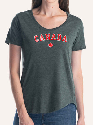 Woman wearing ladies forest green t-shirt with red maple leaf graphic and canada block letters - Made in Canada by Choose Canadian Apparel Co