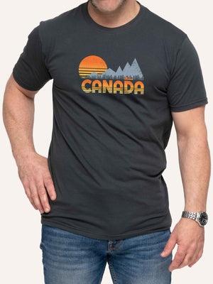 Man wearing grey camping t-shirt with Canada, sunset, canoe, and mountains - Made in Canada by Choose Canadian Apparel Co