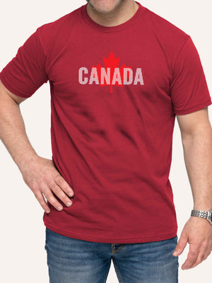 Man wearing red t-shirt with Maple Leaf and vertical white lines - Made in Canada by Choose Canadian Apparel Co