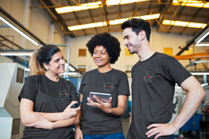 Factory workers wearing shirts promoting Canadian Manufacturing - Made in Canada by Choose Canadian Apparel Co