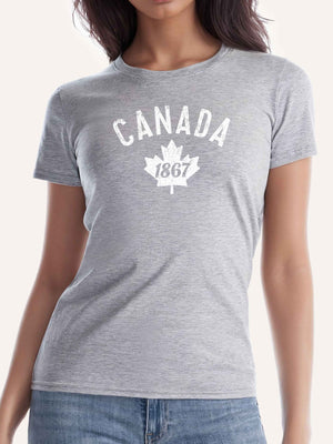 Woman wearing light grey ladies t-shirt with Canada 1867 graphic and maple leaf - Made in Canada by Choose Canadian Apparel Co