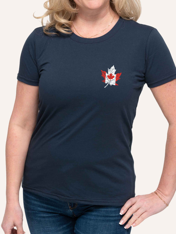 Woman wearing ladies navy blue t-shirt with canada flag in shape of maple leaf graphic at left pocket location - Made in Canada by Choose Canadian Apparel Co