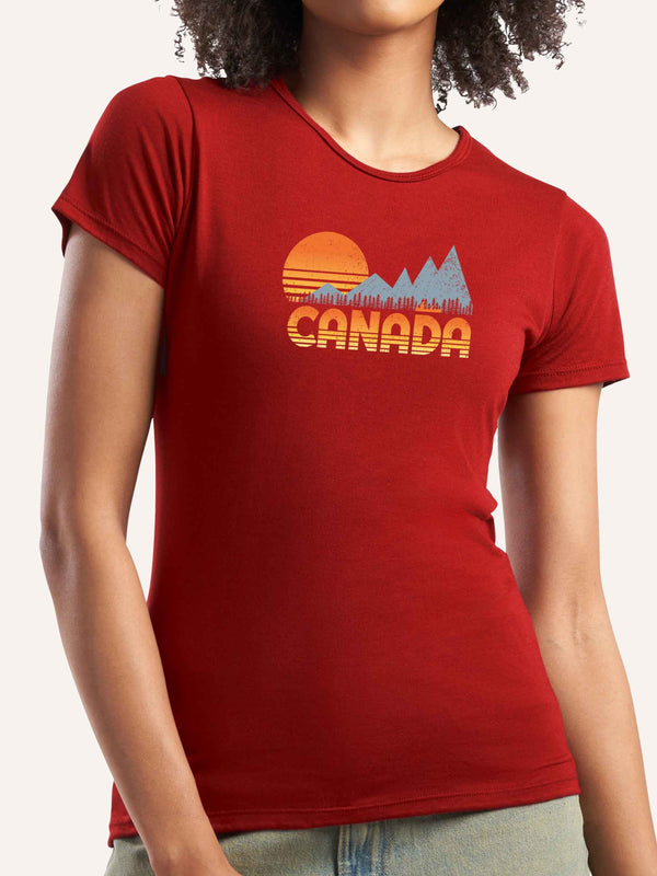Woman wearing red camping t-shirt with CANADA slogan and orange sunset, mountain, trees and canoe graphic - Made in Canada by Choose Canadian Apparel Co