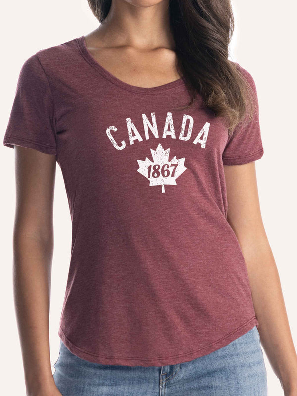 Woman wearing ladies burgundy red scoop t-shirt with canada maple leaf and 1867 graphic - Made in Canada by Choose Canadian Apparel Co