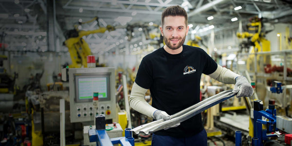 Factory worker wearing a black shirt promoting Canadian Manufacturing - Made in Canada by Choose Canadian Apparel Co